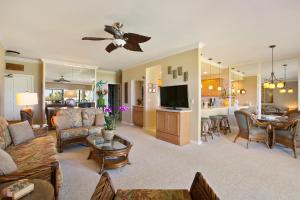 a living room with a couch and a dining room at Prime Oceanfront Condo near Shipwreck Beach - Alekona Kauai in Koloa