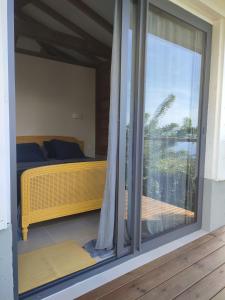 a bedroom with a view of a bed and a window at VillAnolis Martinique in Le Carbet