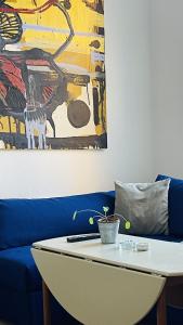 a living room with a blue couch and a table at ApartmentInCopenhagen Apartment 1586 in Copenhagen