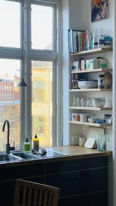 a kitchen with a sink and a window at ApartmentInCopenhagen Apartment 1586 in Copenhagen