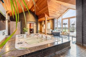 a jacuzzi tub in the living room of a house at Op het Spaan in Berghem