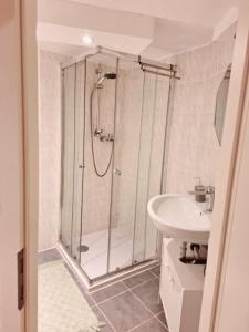 a bathroom with a shower and a sink at Basement Room in Mönchengladbach