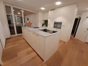 a kitchen with white cabinets and a counter top at Ferienwohnung Brüstiblick in Attinghausen