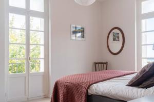 a bedroom with a bed with a red blanket at Regina's Banyuls - Exklusiv lägenhet med havsvy in Banyuls-sur-Mer