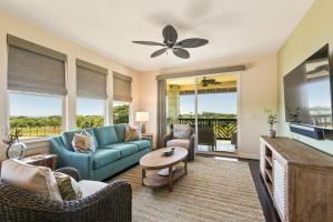 a living room with a couch and chairs and a tv at 3 Bedroom 3 Bathroom Condo with Ocean View - Alekona Kauai in Koloa