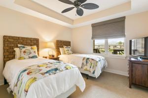 a bedroom with two beds and a window at 3 Bedroom 3 Bathroom Condo with Ocean View - Alekona Kauai in Koloa +19 photos