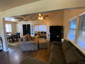 a living room with two couches and a ceiling fan at The Overlook~Bandera, TX in Bandera