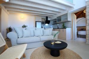 a living room with a white couch and a table at Georgia Villas in Drymon