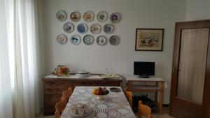 une salle à manger avec une table et des assiettes murales dans l'établissement Chiara Apartment, à Mestre