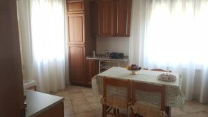 a kitchen with a table with chairs and a table with at Chiara Apartment in Mestre
