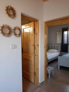 a bedroom with a bed and two mirrors on the wall at Studio with a spacious garden in Al-Assla in Dahab