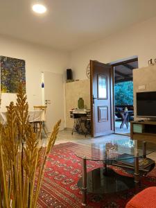 a living room with a door and a table at Apartman "Almond house 2" in Pula