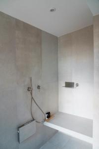 a bathroom with a shower with a hose at Urania Luxury Villa Rhea in Póndi