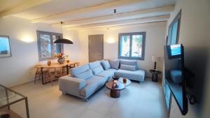 a living room with a couch and a tv at Urania Luxury Villa Rhea in Póndi