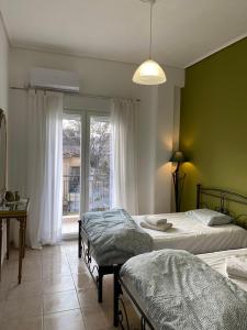 a bedroom with two beds and a window at Nefeli Β1 apartment in Thiva