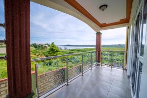 a balcony with a view of the water at Kibibi Lake view furnished suites in Wakiso