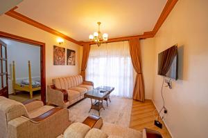 a living room with a couch and a table at Kibibi Lake view furnished suites in Wakiso