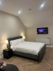 a bedroom with a bed and a tv on the wall at Attic Room in Citywest in Dublin