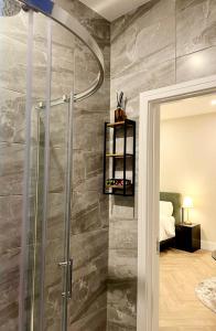 a shower with a glass door in a bathroom at Attic Room in Citywest in Dublin