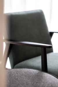 a black chair sitting next to a table at Cozy Apartment in Kalamaria, Thessaloniki in Thessaloniki