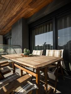 a wooden table with a bowl of bananas on top at Cozy Apartment in Kalamaria, Thessaloniki in Thessaloniki