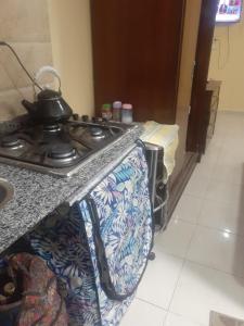 a kitchen with a stove with a tea pot on it at Kazpilkna Beach Neighborhoods in Hurghada