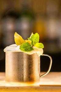 a metal cup with mint leaves on top of it at Meliá Paulista in São Paulo