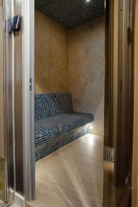 a bench sitting in a room with a hallway at Belle View Apart Hotel in Turda