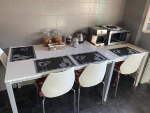 een keuken met een tafel met stoelen en een magnetron bij The New Leone d'Oro of Venice Mestre in Mestre