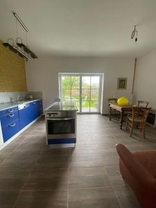 a kitchen with a stove and a table in it at Entzückendes Häuschen, neu ren. in Groß-Siegharts