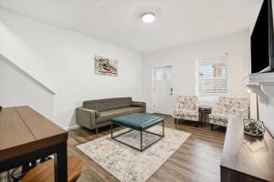 a living room with a couch and a table at Centrally located renovated home in Columbus