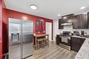 a kitchen with a stainless steel refrigerator and a table at Centrally located renovated home in Columbus