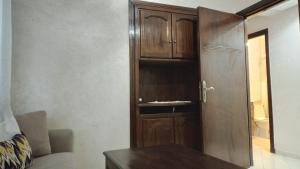 a room with a wooden cabinet and a table at tranquil harmony in Casablanca