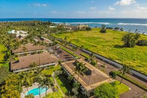 an aerial view of a resort with a pool and the ocean at Plantation Hale J11 in Kapaa