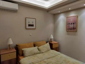 a bedroom with a bed and a picture on the wall at Achilles Apartment in Nafplio +54 photos