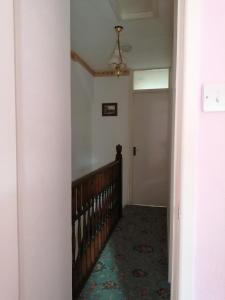 a hallway with a staircase and a ceiling fan at 2 Rhys Terrace in Machynlleth