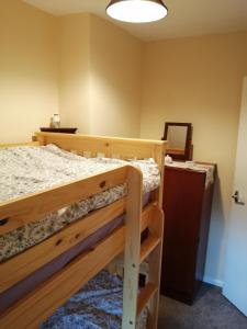 a bedroom with a bunk bed and a mirror at 2 Rhys Terrace in Machynlleth