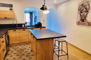 a kitchen with a island in the middle of a room at Merveille de loft vue mer Citadelle de Bonifacio in Bonifacio