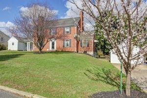 a large brick house with a tree in the yard at Home Sweet Home Suite #3, near Liberty University, and Lynchburg Hospital, Deluxe Queen Size Bedroom in Lynchburg