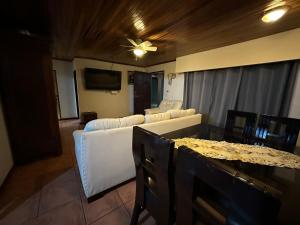 a living room with a couch and a ceiling fan at Casa Mar in Manuel Antonio