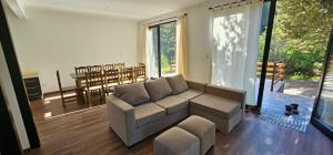 a living room with a couch and a table at Casa del Rio in Villa Meliquina