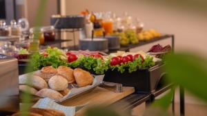 a buffet of food with vegetables and bread at Good Morning Bologna in Bologna
