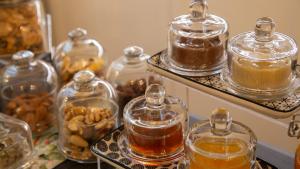 a group of glass jars of honey on a table at Good Morning Bologna in Bologna