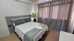 a bedroom with a bed with a white phone on it at Hotel e Restaurante do Baixinho in Planalto