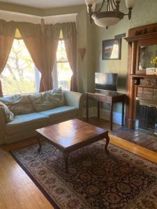 a living room with a couch and a coffee table at Large Private room with Queen bed - 2a in Chicago