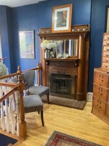 a living room with a fireplace and a chair at Large Private room with Queen bed - 2a in Chicago