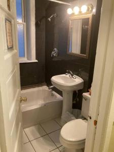 a bathroom with a white toilet and a sink at Large Private room with Queen bed - 2a in Chicago