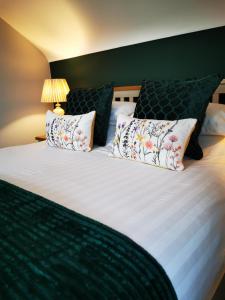 a bedroom with a large bed with pillows at Ocean Heights B&B in Lissadell