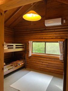 a room in a log cabin with a window at Nasu Takahara Auto Campsite - Vacation STAY 42065v in Nasushiobara