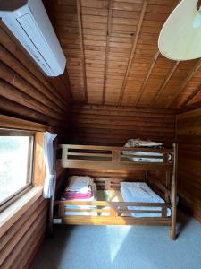 a room with two bunk beds in a cabin at Nasu Takahara Auto Campsite - Vacation STAY 42065v in Nasushiobara